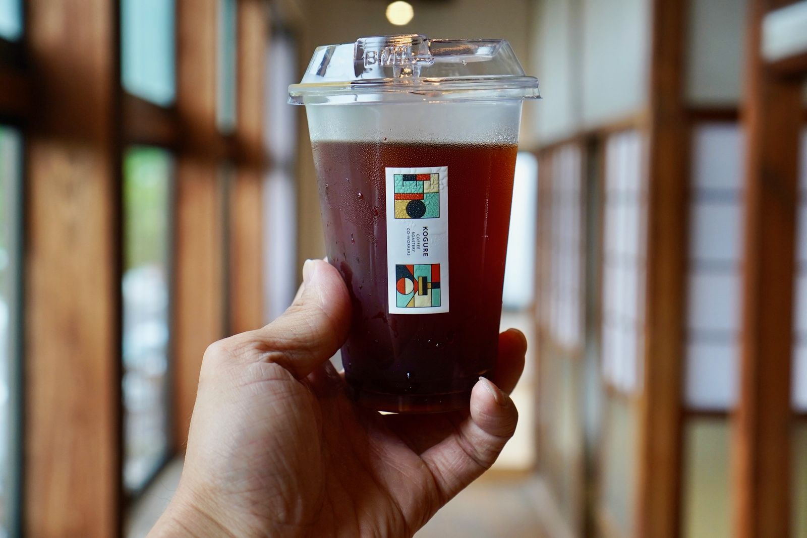 佐賀・唐人の店内でアイスコーヒーを手にする様子