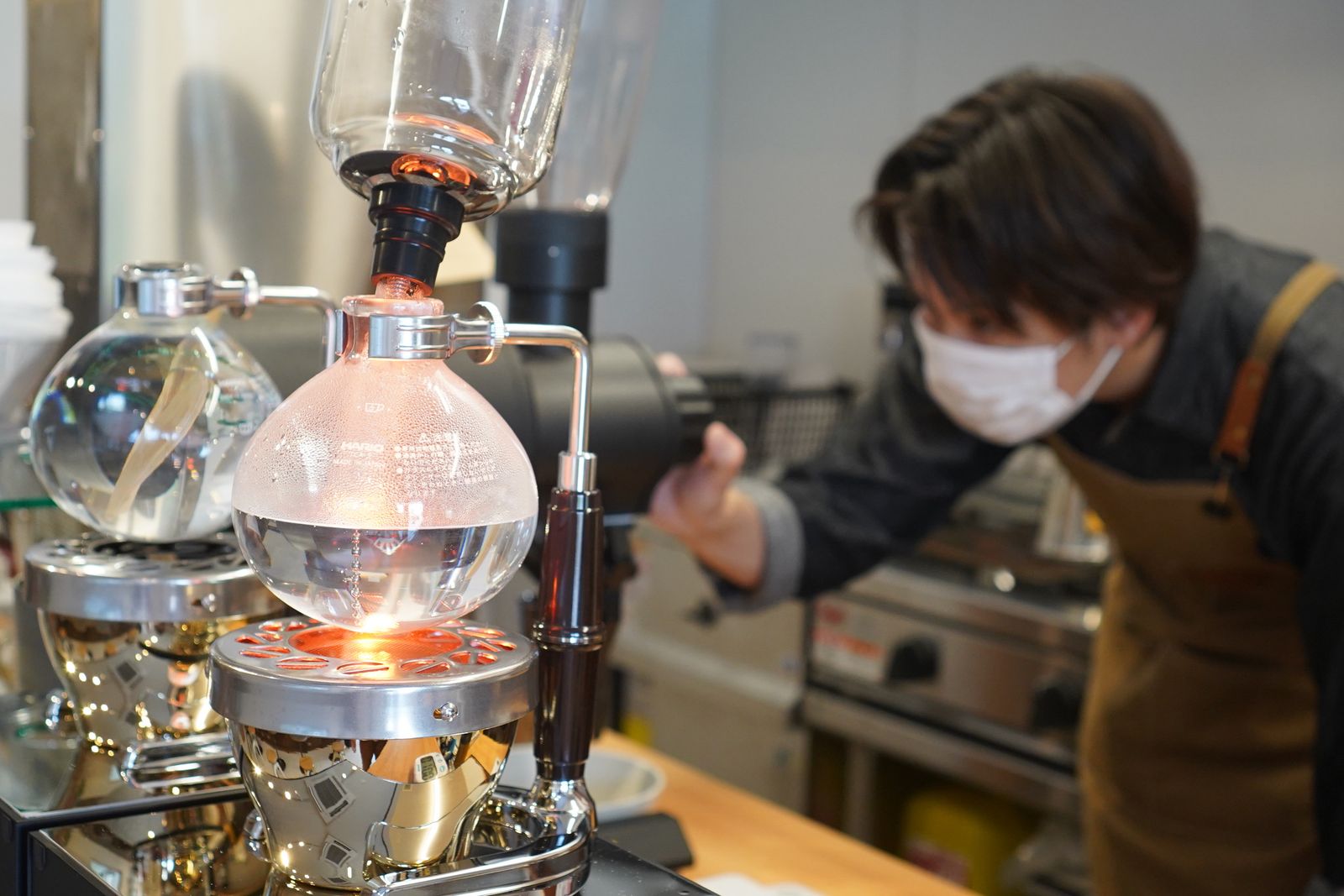 サイフォンでコーヒーを淹れるスタッフの様子